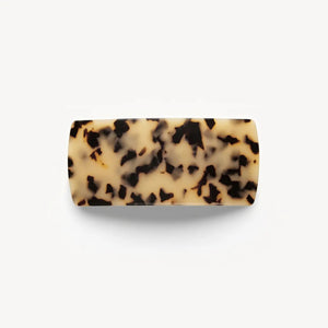 The MACHETE - Jumbo Box Barrette in Blonde Tortoise features a rectangular Italian acetate design with a beige and black tortoiseshell pattern, showcased against a plain white background.