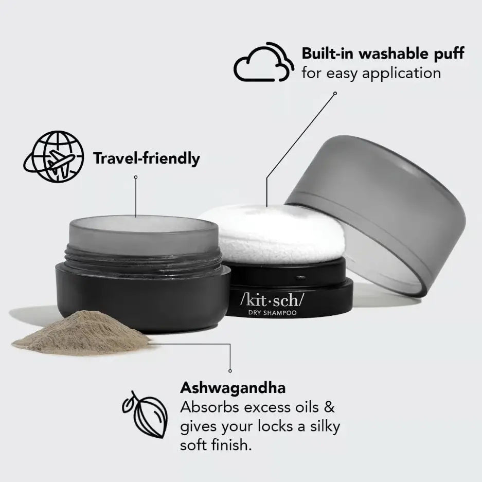 A small, round black container with a matte gray cap labeled "KITSCH Volumizing Rice Protein Dry Shampoo - Dark Tinted" rests on a light gray background—ideal for absorbing oil and refreshing dark hair.