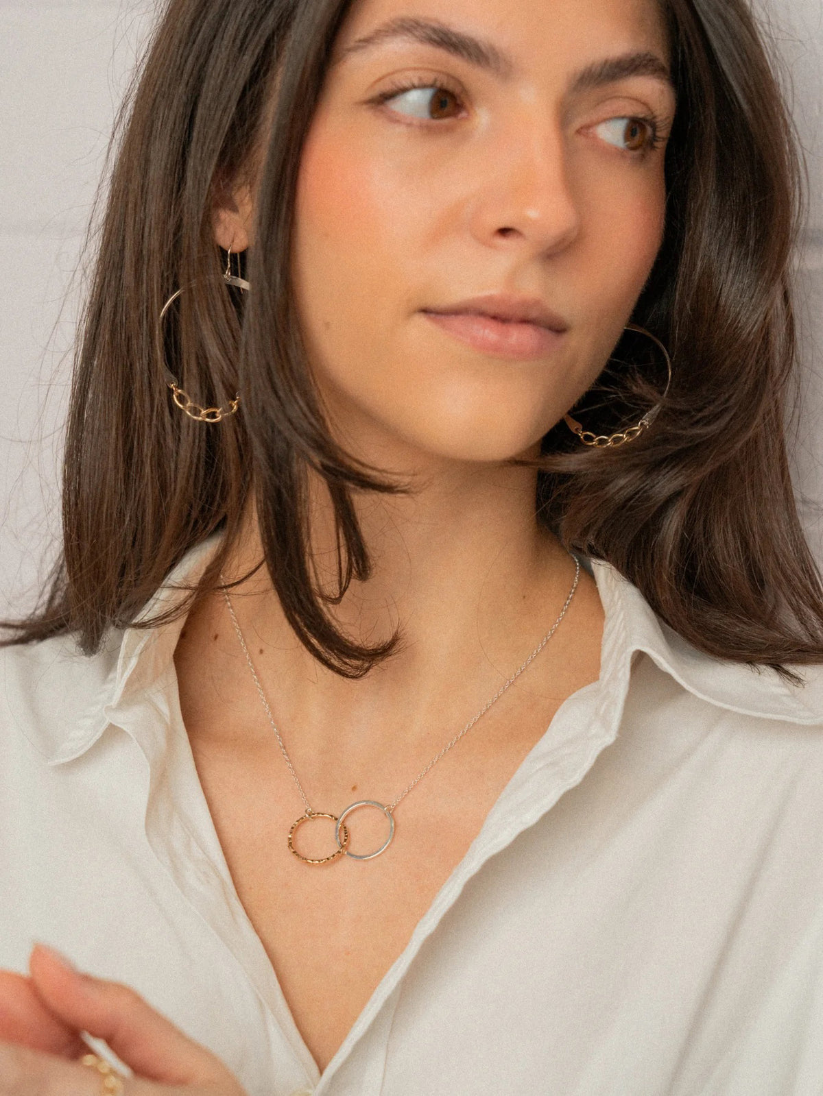 A close-up of KENDA KIST - THE BFF NECKLACE by KENDA KIST, a stunning two-tone interlocking circle necklace, perfect for celebrating friendship.