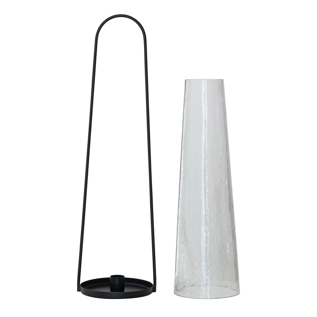 The CREATIVE COOP ROUND METAL LANTERN TAPER HOLDER features a tall, hammered glass hurricane in a minimalist black metal frame with a rounded handle—ideal as a lantern holder for modern spaces.