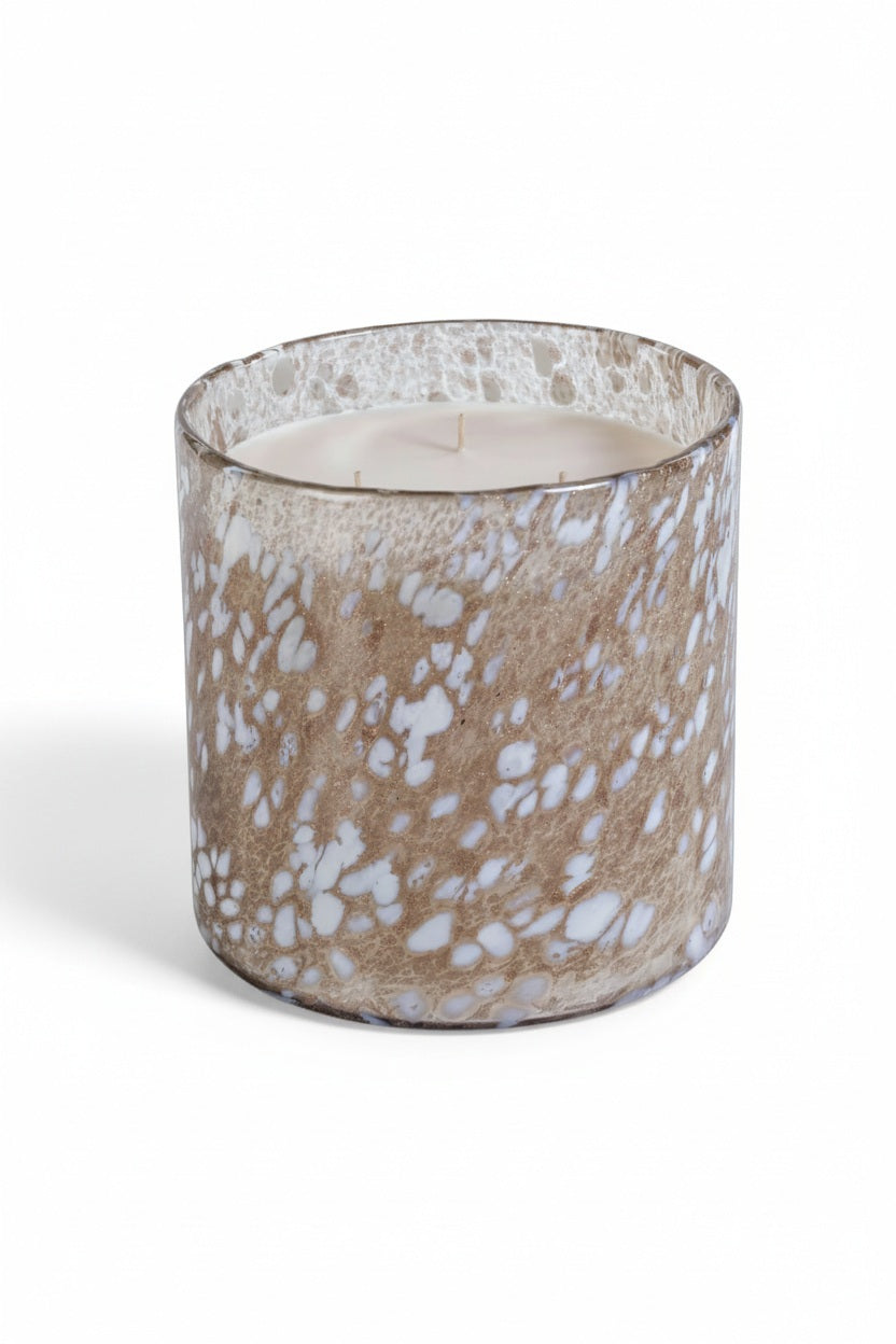 ZODAX TONKA ABSOLUTE SPECKLED LUMIN CANDLE, a three-wick scented candle in a cylindrical glass jar with a brown and white speckled pattern.