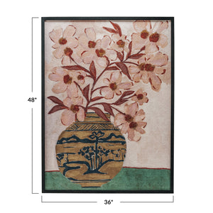 Introducing the WOOD FRAMED FLORAL WALL ART - PINK FLOWERS IN CHINOISERIE VASE from CREATIVE COOP. This oversized wall decor showcases a painting of pink flowers with red stems arranged in a decorative chinoiserie vase adorned with an intricate landscape pattern of trees, hills, and water. Set against a background that transitions from light pink above to green below, this elegant piece is beautifully framed in black wood, making it a striking addition to any space.