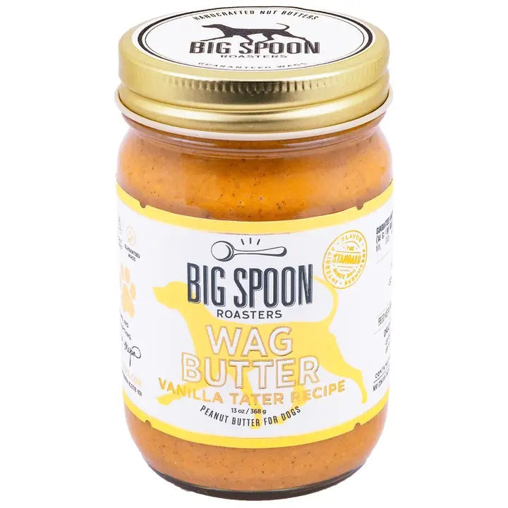 BIG SPOON ROASTERS WAG BUTTER VANILLA TATER is a handmade nut and peanut butter for dogs, with a gold lid and white label with yellow accents and a dog silhouette—an irresistible treat from BIG SPOON ROASTERS.