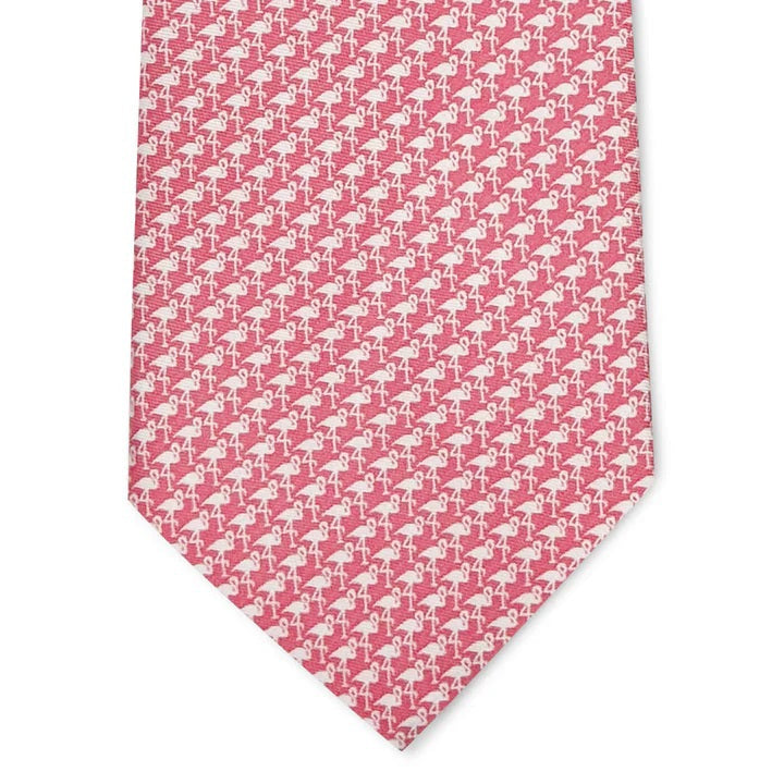 A rolled-up pink Flamingo Silhouette printed silk tie by Bird Dog Bay, handmade in New York.