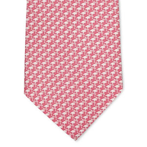 A rolled-up pink Flamingo Silhouette printed silk tie by Bird Dog Bay, handmade in New York.