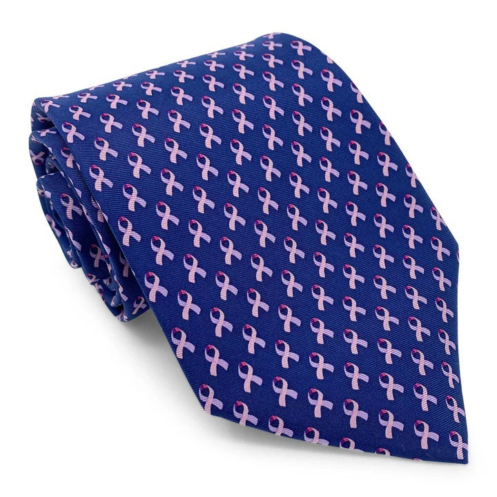 The BIRD DOG BAY - CARE FOR A CURE™ Silk Tie in Navy features a repeating pattern of small pink awareness ribbons, symbolizing breast cancer awareness.