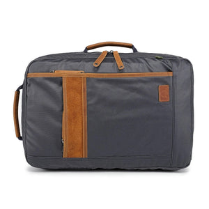 The TSD BRAND - MADRONE COATED CANVAS BACKPACK IN NAVY features brown leather accents, a spacious main compartment, a padded laptop sleeve with snap closure, and multiple zippered pockets on the inside flap.