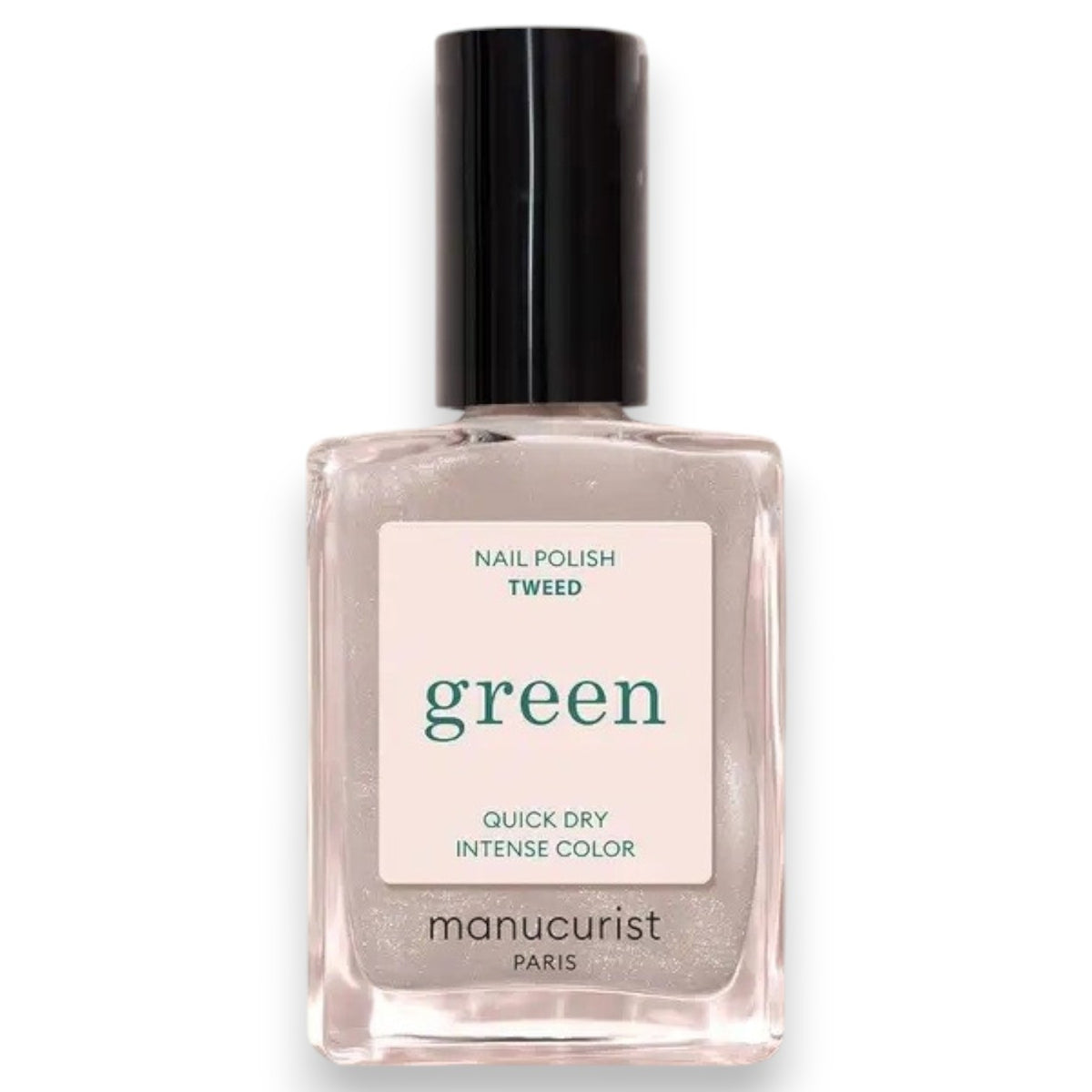 A hand painted with MANUCURIST - GREEN™ NAIL POLISH IN TWEED by MANUCURIST INC, a short pearly grey shade, rests on a shiny red surface. The person wears a gold ring featuring a large green stone on their middle finger, while a green and white bowl is partially visible in the corner.