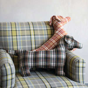 The CREATIVE COOP PLAID DOG-SHAPED PILLOWS, shown here in brown-green and red-orange patterns on a white background, bring cozy farmhouse style to any space.