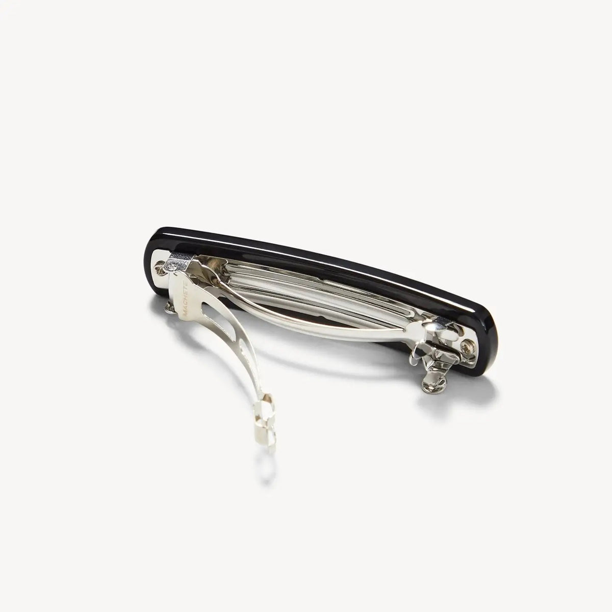 The MACHETE - NO. 3 Heirloom Barrette in Black, a sleek rectangular hair accessory with rounded edges crafted from premium cellulose acetate, is displayed against a plain white background.