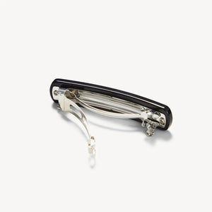The MACHETE - NO. 3 Heirloom Barrette in Black, a sleek rectangular hair accessory with rounded edges crafted from premium cellulose acetate, is displayed against a plain white background.