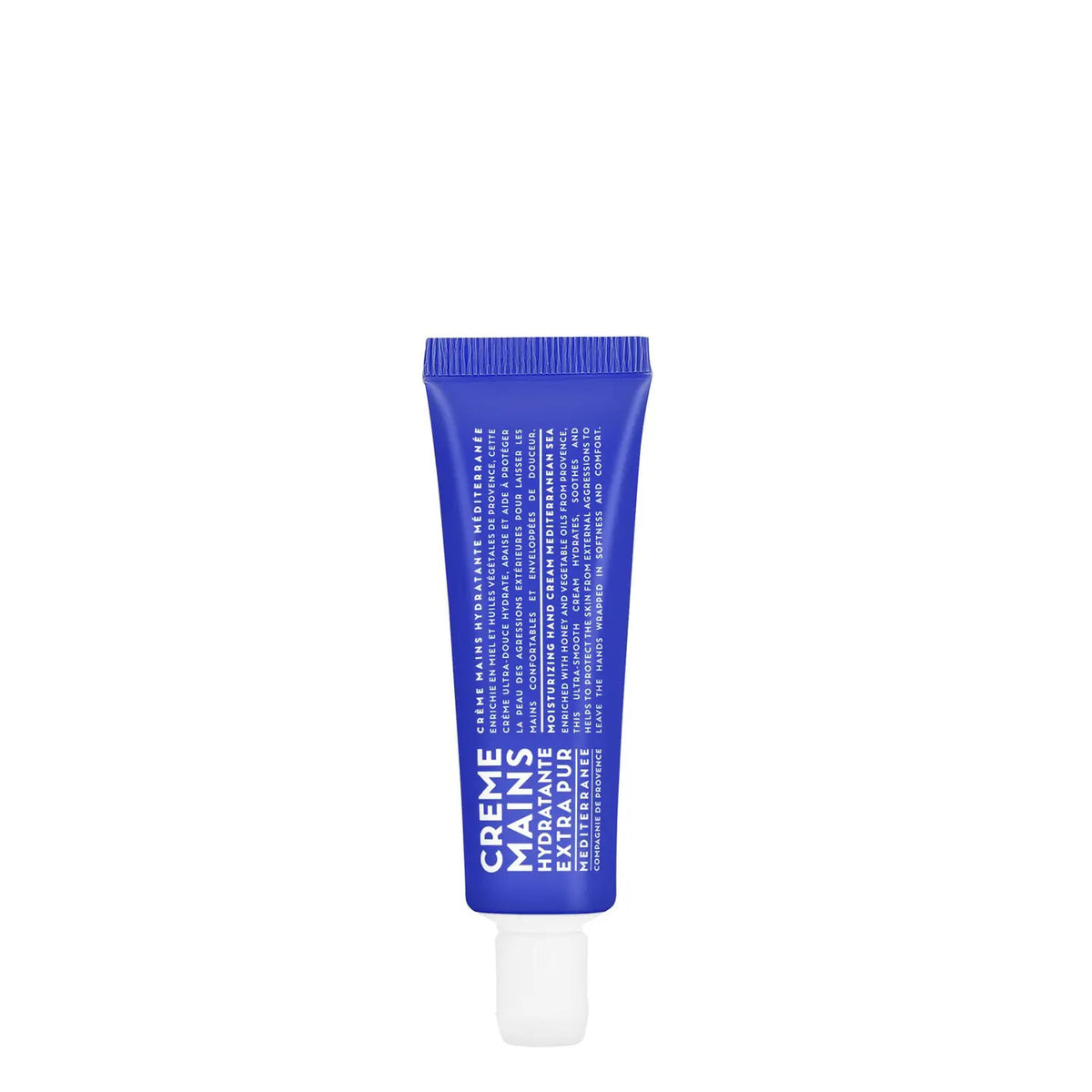 A blue tube labeled "Crème Mains" with white text contains COMPAGNIE DE PROVENCE TRAVEL HAND CREAM MEDITERRANEAN SEA 1OZ by CIE LUXE BRANDS; it features French details, botanical oils and a white cap, standing upright on a plain background.