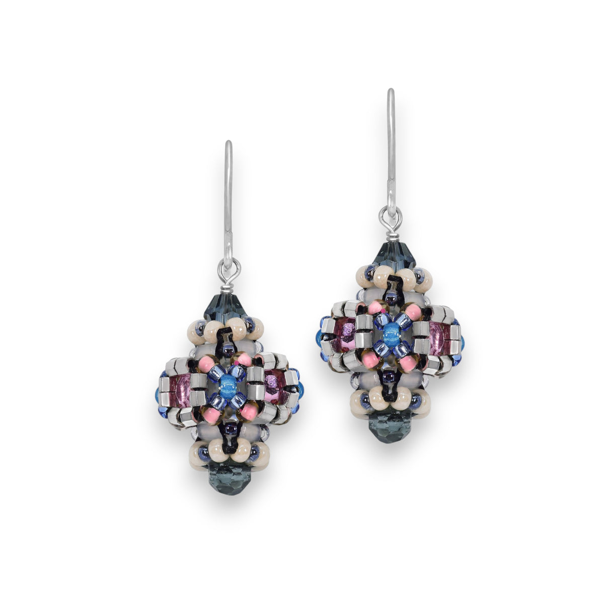 Elegant handcrafted earrings featuring intricate beadwork in blue, pink, and silver tones. The MIGUEL ASES - CRYSTAL MIYUKE DROP EARRINGS by MIGUEL ASES, INC. showcase drop-shaped accents with a floral-like motif that resembles a small, ornate geometric pattern.
