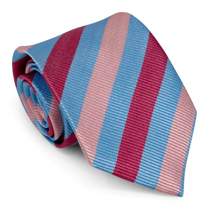 The PETER-BLAIR - CAGNEY WOVEN SILK TIE IN BLUE, PINK AND RED by BIRD DOG BAY features bold diagonal stripes, a subtle ribbed texture, and is handmade in New York for a sophisticated finish.