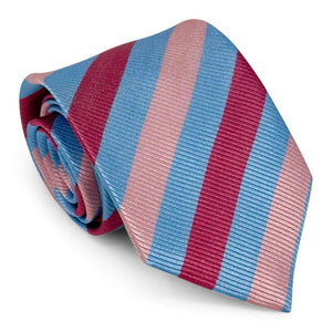 The PETER-BLAIR - CAGNEY WOVEN SILK TIE IN BLUE, PINK AND RED by BIRD DOG BAY features bold diagonal stripes, a subtle ribbed texture, and is handmade in New York for a sophisticated finish.