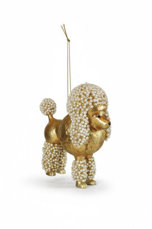 POODLE ORNAMENT WITH FAUX PEARLS, a gold glass poodle decorated with faux pearls on its head, tail, and legs, suspended by a gold string.