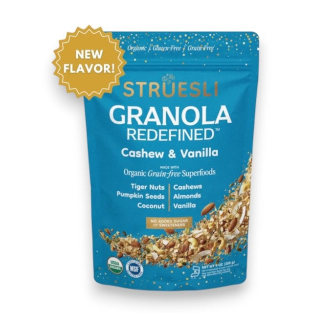 A blue pouch of STRUESLI - Cashew & Vanilla Granola by STRUESLI, showcasing highlights such as keto-friendly, organic, grain-free, new flavor, with visible mixed nuts and seeds displayed on the lower half of the packaging.