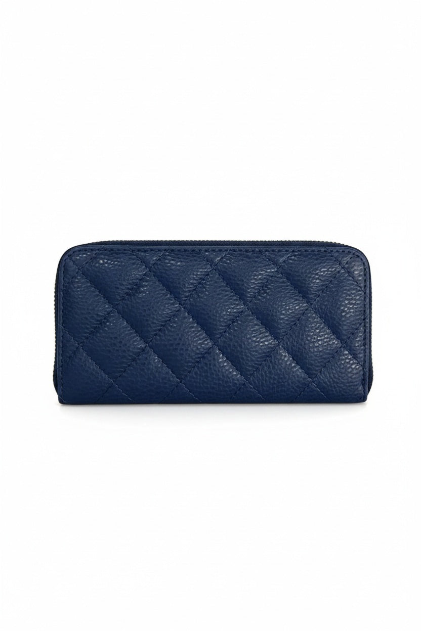 A light blue LE BORSETTE LEATHER QUILTED WALLET with diamond stitching on a white background features a zip-around closure, gold zipper pull, and multiple card slots.