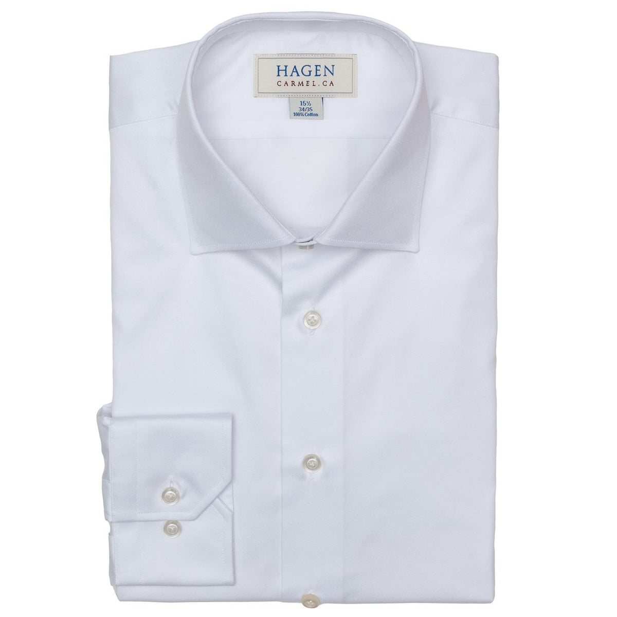 The HAGEN - COTTON DRESS SHIRT IN WHITE features premium cotton, a modern spread collar, and buttoned cuffs. The shirt displays the "HAGEN" brand label and is shown neatly folded against a plain white background.