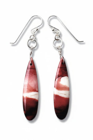 The ANN LIGHTFOOT Mookite Drop Earrings boast a long, teardrop shape with a stunning marbled design in vibrant red and white hues. Mounted on sterling silver hooks, they are beautifully showcased on a pristine white background.