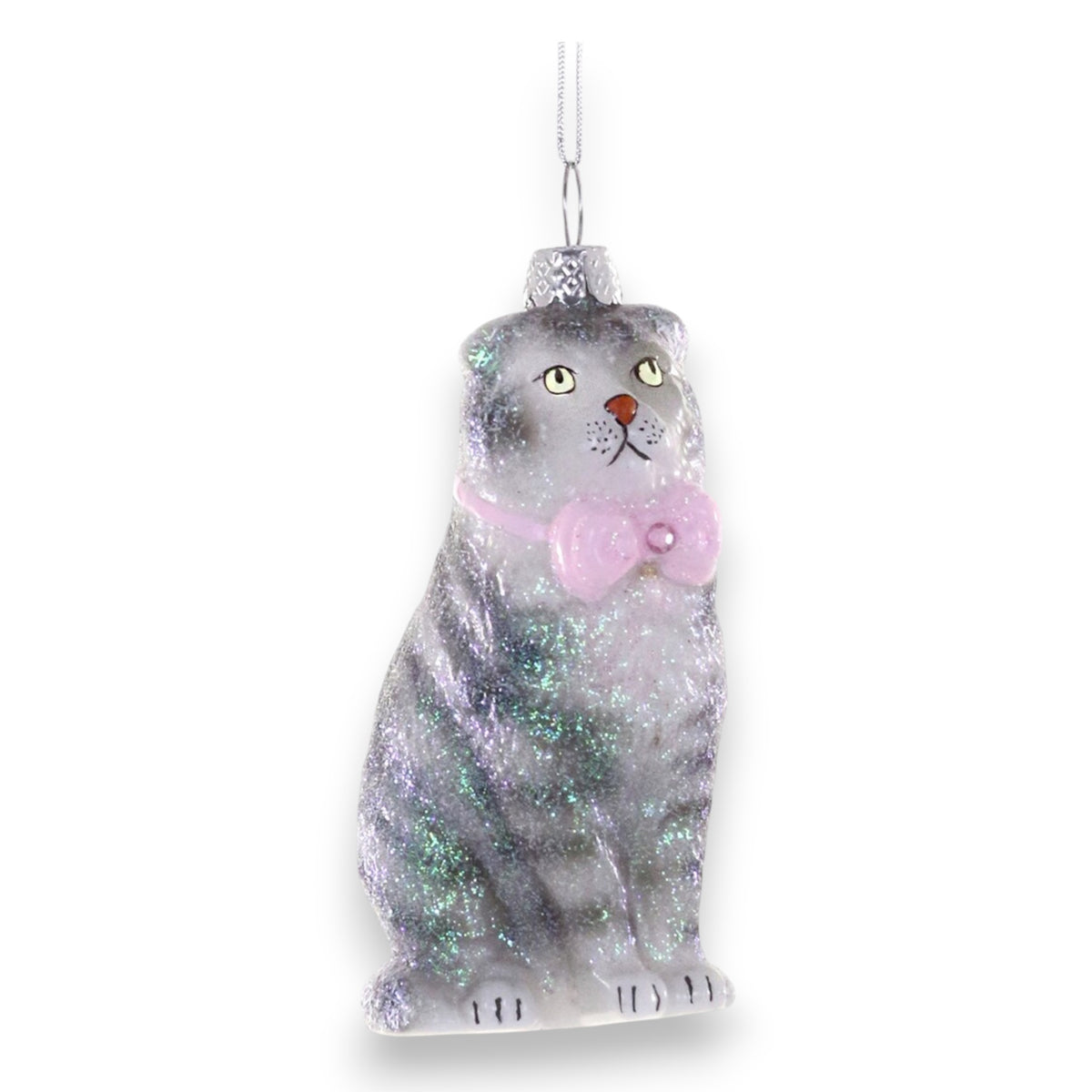 The SCOTTISH FOLD CAT ORNAMENT by CODY FOSTER features a sparkly gray cat with yellow eyes, a red nose, a pink bow tie, and a silver top hat, hanging by a silver string—perfect for vintage-inspired holiday collections.
