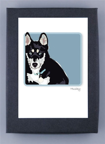 The illustration of a black and white dog with pointed ears, a blue collar, on a light blue background is framed in black on recycled paper. Named "Husky," it's proudly crafted in the USA by PAPER RUSSELLS as part of their HUSKY BOX NOTES collection.