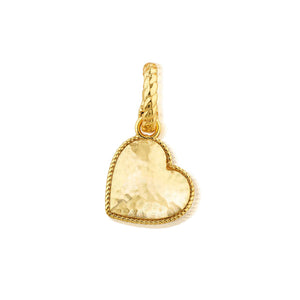 The CAPUCINE DE WULF - LOVE PENDANT by CAPUCINE DE WULF is an 18K gold handmade heart pendant with a hammered texture, twisted rope border, and textured loop. Its anti-tarnish finish ensures lasting shine against a white background.