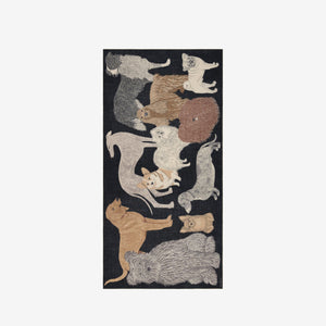 The INOUI EDITIONS - TOUTOU DOGGIE WOOL SCARF by INOUI features illustrated dogs of various breeds, sizes, and colors playfully arranged on a dark background. Made in India.