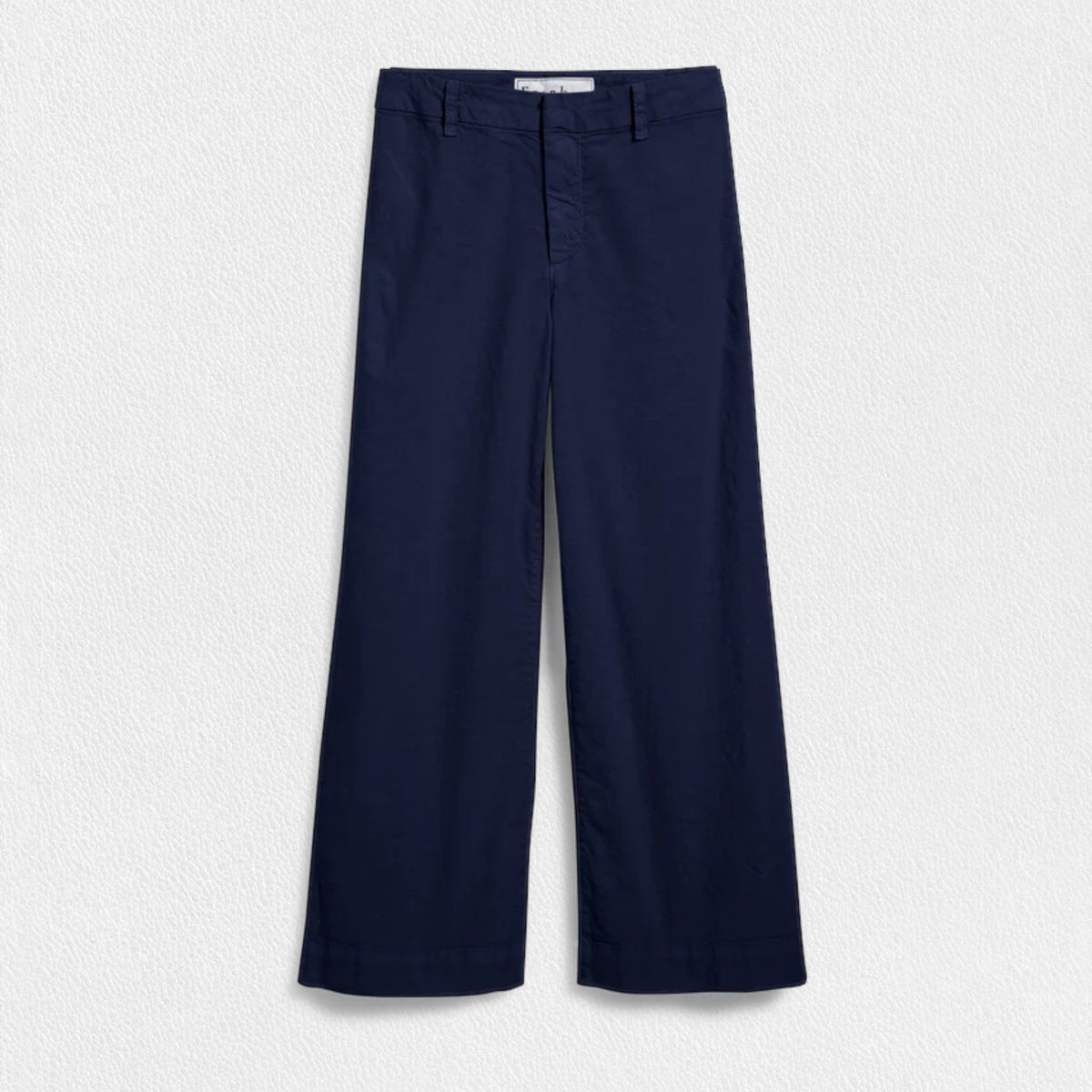 The FRANK &amp; EILEEN Wexford Wide Leg Linen Pant in Navy is showcased against a light textured background. These high-rise trousers, crafted from Italian Performance Linen, feature a flat front and straight hem with a clean and minimalist design, absent of visible pockets or embellishments.