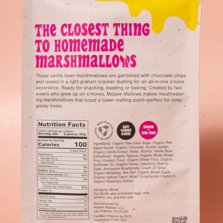 A standing pouch of MOJAVE MALLOWS - S’MORE SPECKLED MARSHMALLOWS by MOJAVE MALLOWS, showcasing bold pink and yellow lettering with playful graphics on a cream background. The packaging emphasizes these organic s’more marshmallows—decadent chocolate chip treats dusted with graham cracker, ideal for anyone seeking artisanal marshmallows with a unique twist.