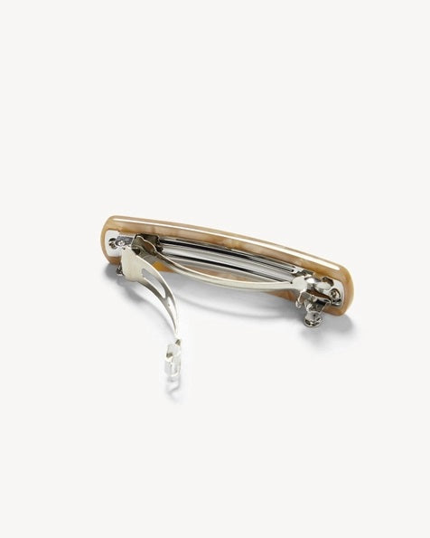 The MACHETE No. 3 Heirloom Barrette in Sand Shell is a rectangular, beige, and glossy hair clip, handcrafted in France from luxurious Italian acetate. It features a crinkled, reflective surface pattern and is shown against a plain white background.