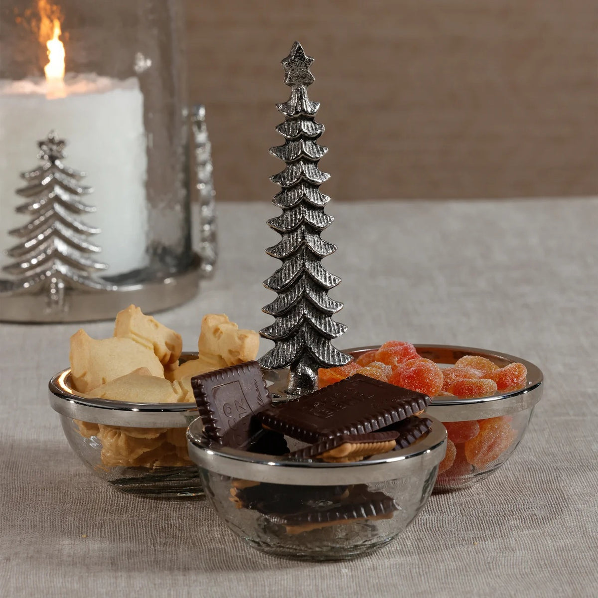 ZODAX GLASS AND METAL TRIO CONDIEMNT SET featuring three clear glass bowls with silver rims arranged around a central steel construction Christmas tree handle.