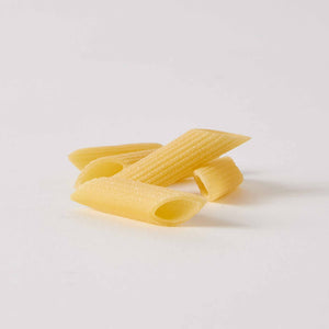 A light blue package of ATALANTA CORPORATION's CIPRIANI - ORGANIC DURUM WHEAT PENNE PASTA stands against a plain white background. The bag features a transparent window displaying the high protein index pasta inside and text detailing its Italian organic semolina content.