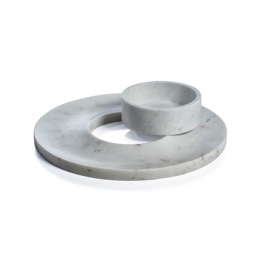 The ZODAX MARBELLA MARBLE CHIP &amp; DIP SERVER is a round, white marble platter with subtle gray veining and a center bowl for dip. It measures 35.56 cm x 5.08 cm (14 in x 2 in) and is perfect for serving chips and dip.