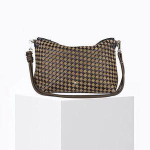 The CRAIE STUDIO - MALLOW TRESSE SEPIA NOIR HANDBAG is a checkered brown and black intrecciato bag featuring a knotted strap, displayed on a white pedestal against a plain white background. This crossbody design from CRAIE STUDIO highlights the artistry of braided leather handbags in a timeless silhouette.