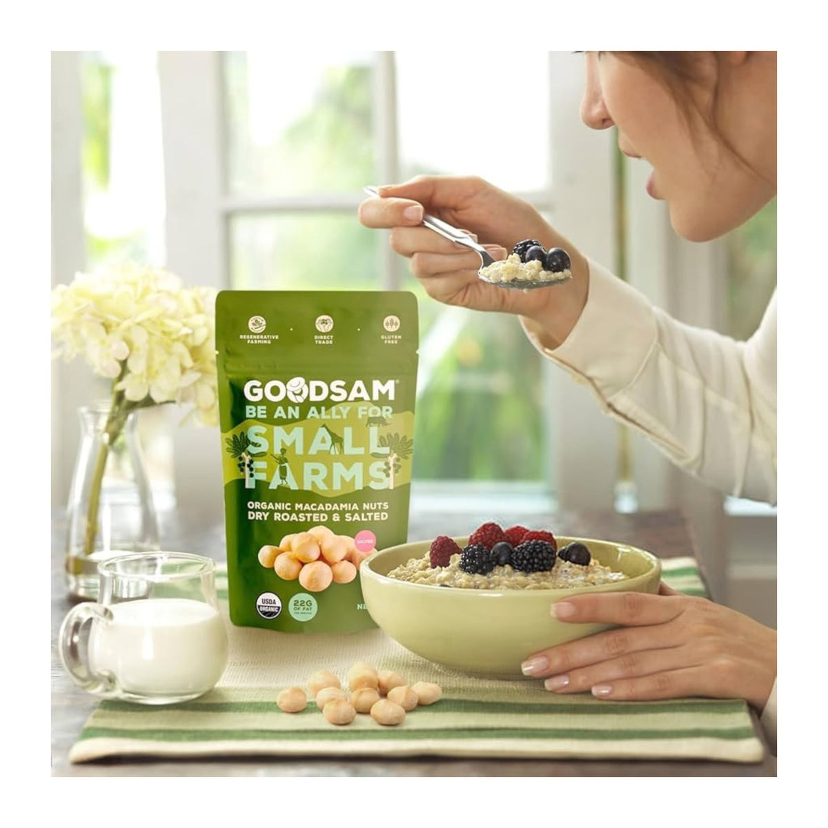 A green bag of GOODSAM FOODS ORGANIC MACADAMIA NUTS, DRY ROASTED &amp; SALTED, shows macadamia images, USDA Organic badge, 22g fat per serving, and highlights a creamy texture, roasted flavor, and support for small farms in bold text.