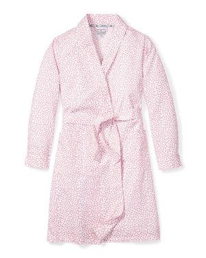 The PETITE PLUME - SWEETHEARTS ROBE by PETITE PLUME is a luxurious bathrobe that showcases a delightful small floral print pattern in pink and white. Crafted from the finest quality cotton, this elegant robe features long sleeves, a shawl collar, and a matching belt tied at the waist. The soft and comfortable fabric makes it perfect for lounging in style.