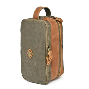 The TSD BRAND Turtle Ridge Toiletry Bag in Olive features leather accents and durable waxed canvas. Grooming essentials fit neatly in elastic loops and mesh pockets, making it the perfect travel companion.