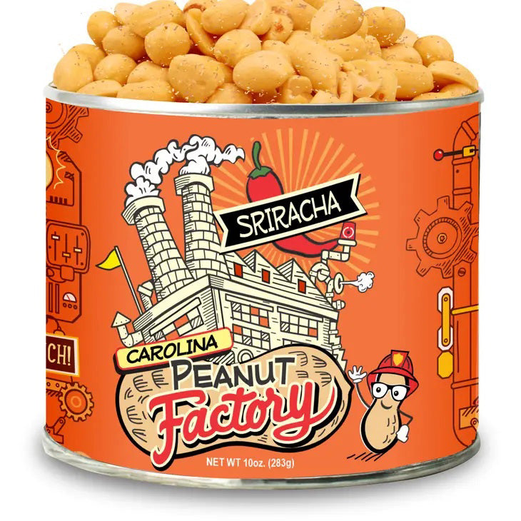 A 10 oz can labeled "1949 NUT COMPANY - SRIRACHA PEANUTS" features a cartoon peanut in a hard hat, bold orange machinery graphics, a spicy red chili pepper, and an illustrated factory on the label.