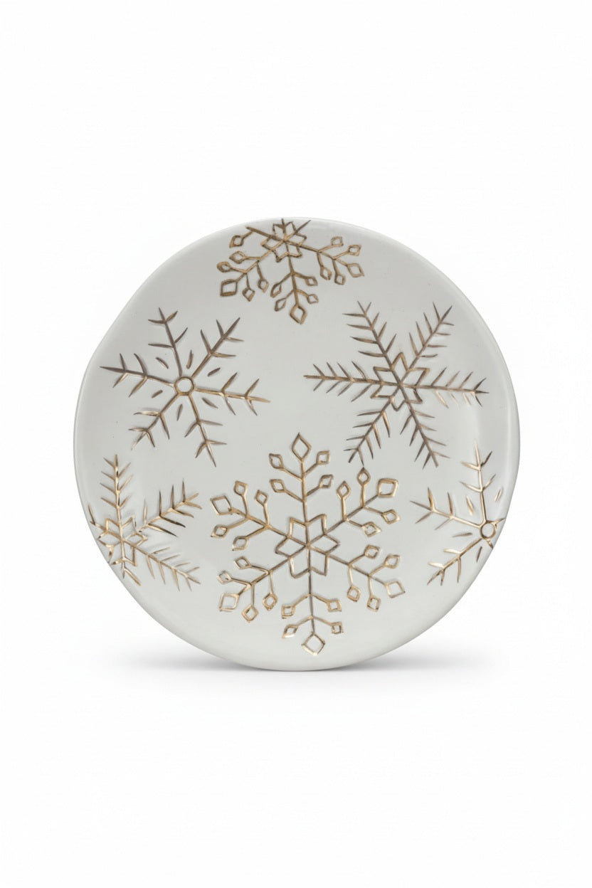 Creative Co-op round white stoneware PLATE WITH GOLD ELECTROPLATED SNOWFLAKES decorated with gold electroplated snowflake patterns.