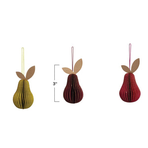 Five HANDMADE RECYCLED HONEYCOMB PAPER PEAR ORNAMENTS by CREATIVE COOP, featuring vibrant colors and textured paper leaves, are displayed atop beige books against a plain light gray background.