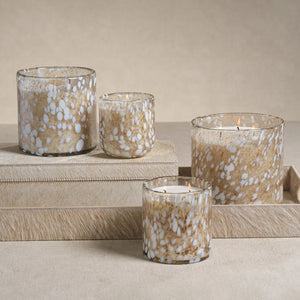 ZODAX TONKA ABSOLUTE SPECKLED LUMIN CANDLE, a three-wick scented candle in a cylindrical glass jar with a brown and white speckled pattern.