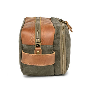 The TSD BRAND Turtle Ridge Toiletry Bag in Olive features leather accents and durable waxed canvas. Grooming essentials fit neatly in elastic loops and mesh pockets, making it the perfect travel companion.
