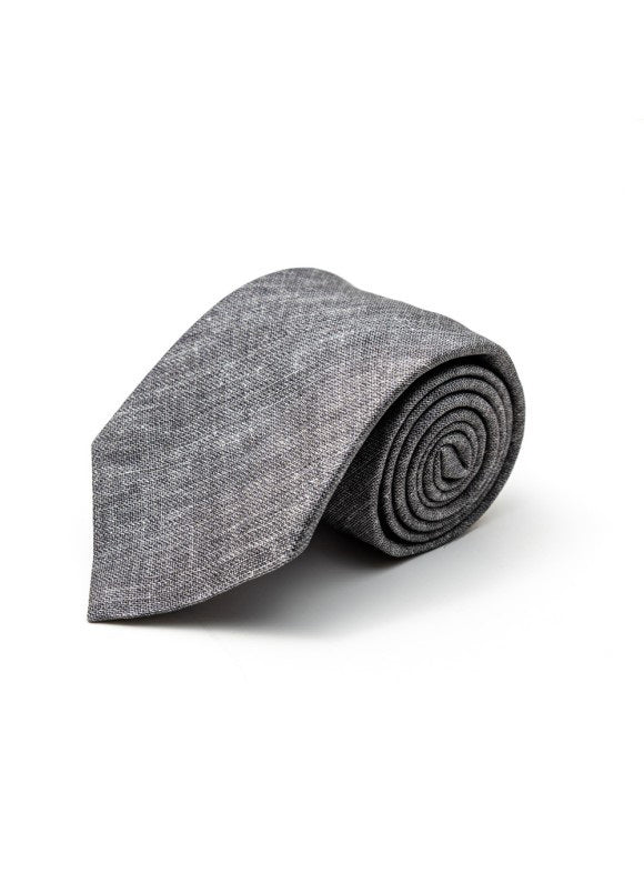The EDWARD ARMAH - SOLID GREY SILK TIE by EDWARD ARMAH, featuring a textured finish, is shown rolled up against a white background.