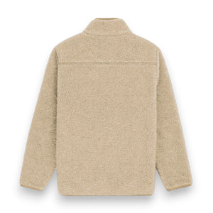 The AMUNDSEN SPORTS - HEROES WOOL FLEECE JACKET is a beige sherpa fleece zip-up with a high collar, large front pockets, and a contrasting waxed cotton chest pocket with a white label, offering a cozy, casual look.