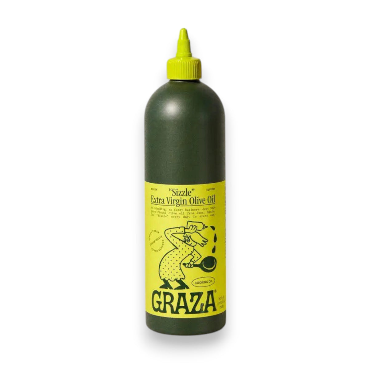 A green bottle with a yellow label containing GRAZA - SIZZLE OLIVE OIL from the brand Graza is placed on a light-colored surface against a neutral background. The label, featuring an illustration of a person pouring olive oil and cooking-related text and graphics, proudly showcases its high-quality picual olive origins.