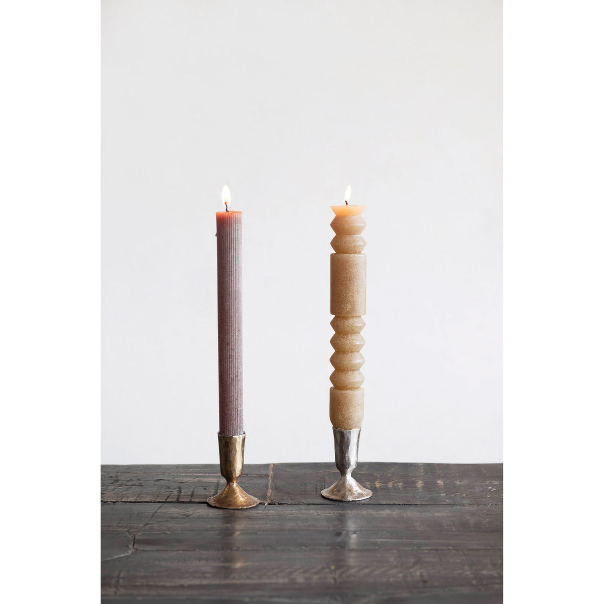 The HAND-FORGED CAST IRON TAPER HOLDER by CREATIVE COOP features a rustic, handmade look with a wide flared base, cylindrical shape, textured surface, and natural aged patina—reminiscent of an antique brass candle holder.