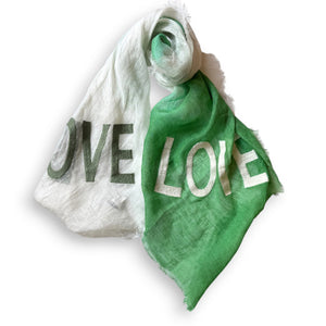 Discover the CITRUS FASHIONS OMBRE LINEN LOVE SCARF, an elegant blend of colors and emotions with one half in vibrant orange and the other in pure white. This dip-dyed treasure spells "LOVE" in contrasting letters, adding warmth and charm to any outfit.