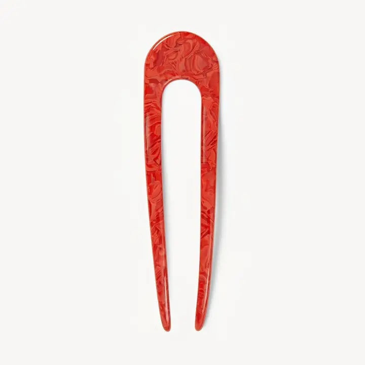 A smooth, black MACHETE - FRENCH HAIR PIN with two prongs, crafted from Italian acetate by MACHETE, rests on a plain white surface.