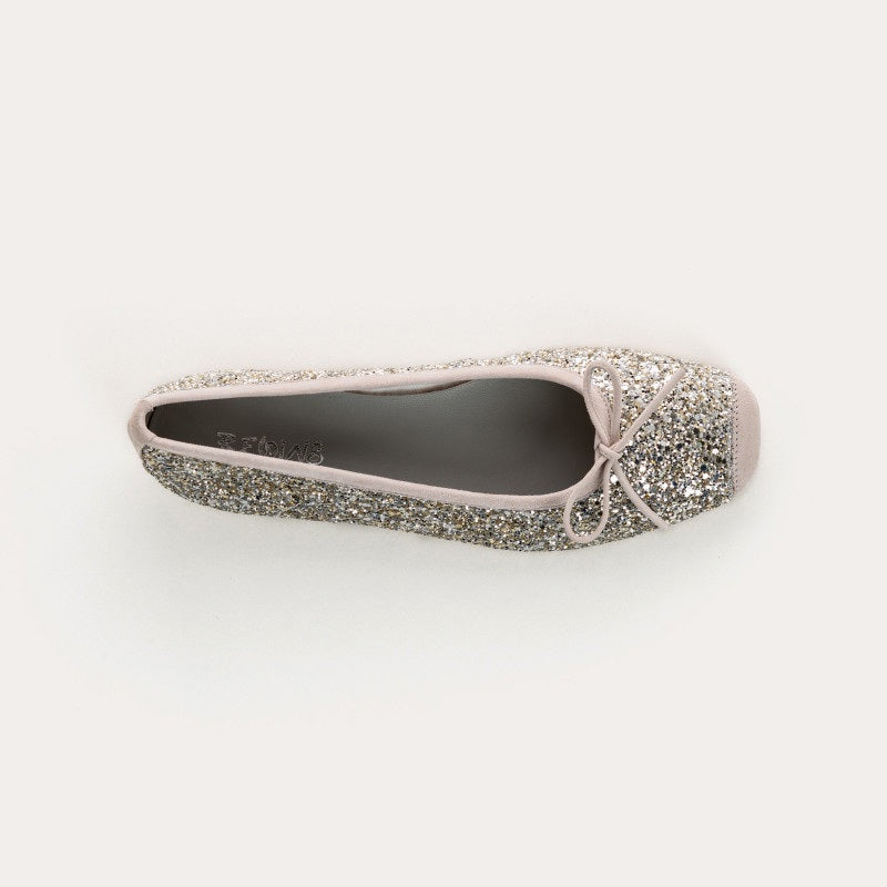 The REQINS HARMONY Sequin Ballerina Flat in Ice features a sparkling design with subtle pink trim and a small bow on the toe, shown from above against a plain light background.